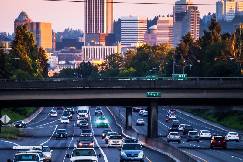 view of a traffic commute with Portland Oregon in the background, Most Asked Questions about Moving to Portland Oregon